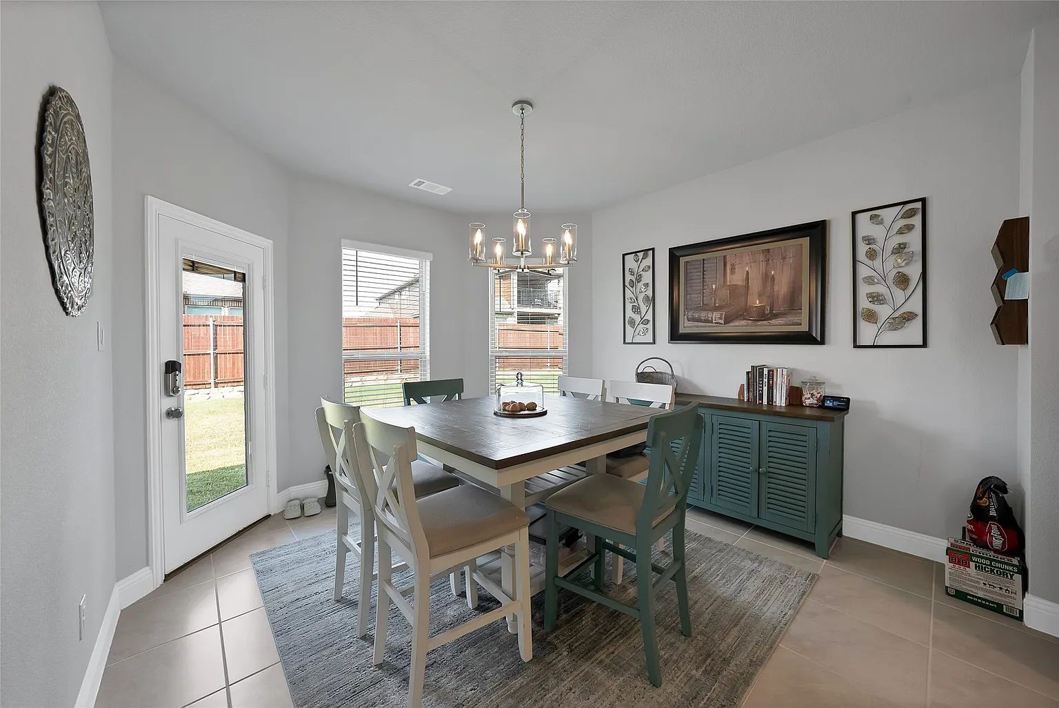 Dining table beside kitchen windows and the rear door.