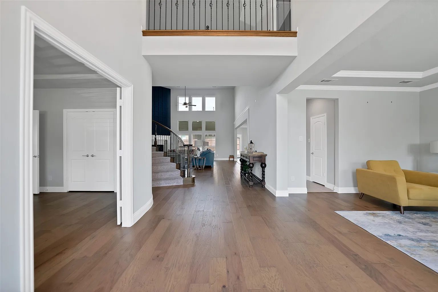 Front entry hall with engineered hardwood flooring and a view to the staircase.