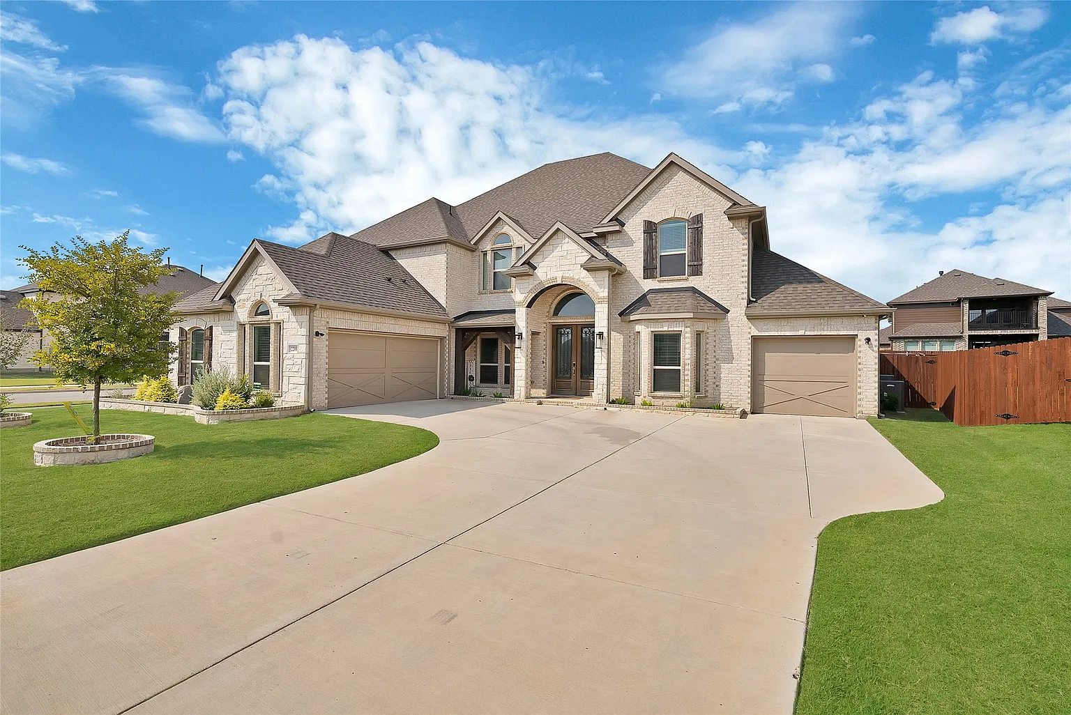 Front approach showing the attached garage and driveway.