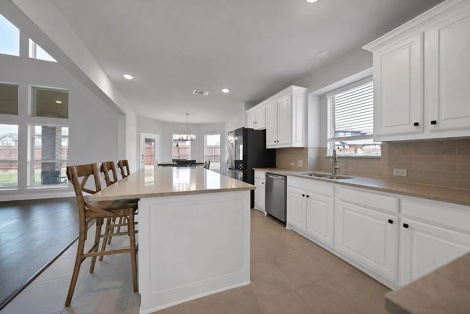 Kitchen island, sink, counters and cabinetry in the open living area.