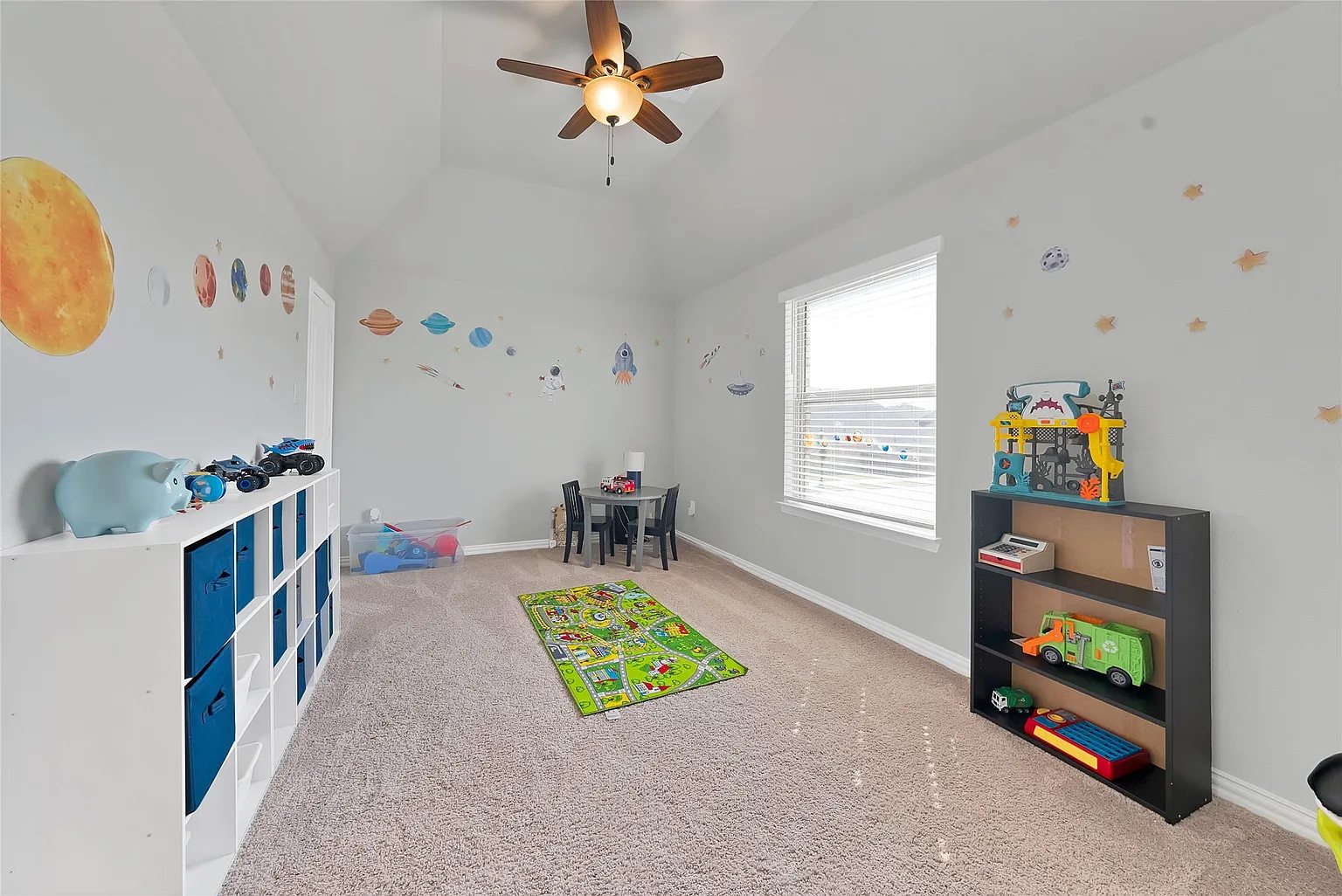 An additional room currently arranged with toys and play furniture.